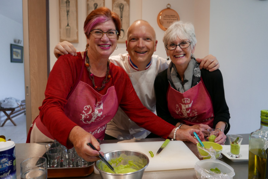  cooking class loire valley tour itinerary, two happy women and one man, are cooking