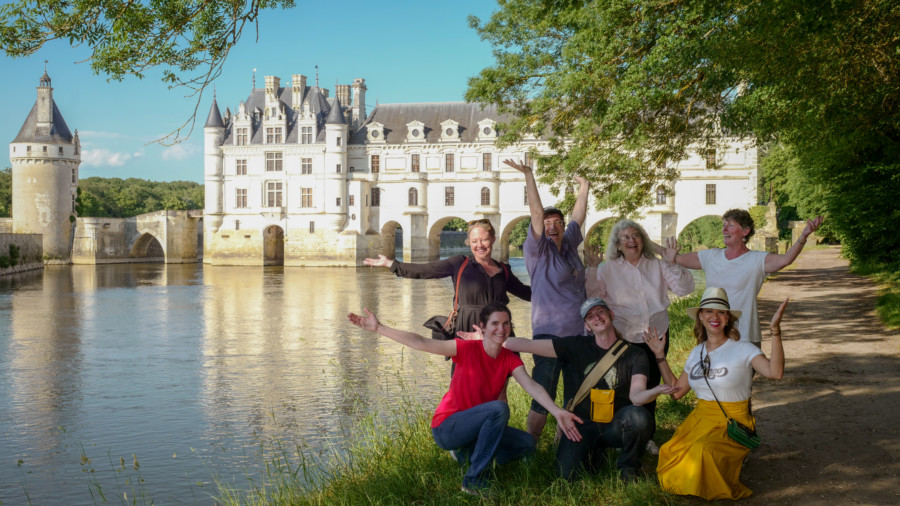People posing and waving in front of the castle and Loire river, Loire Valley Tour Itinerary