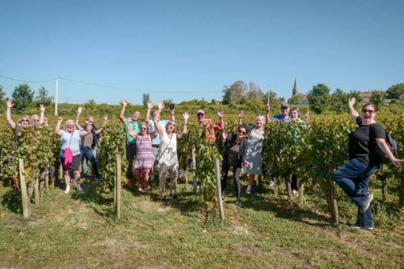 Tour guests enjoying a stroll through the iconic vineyards of Saint Emilion