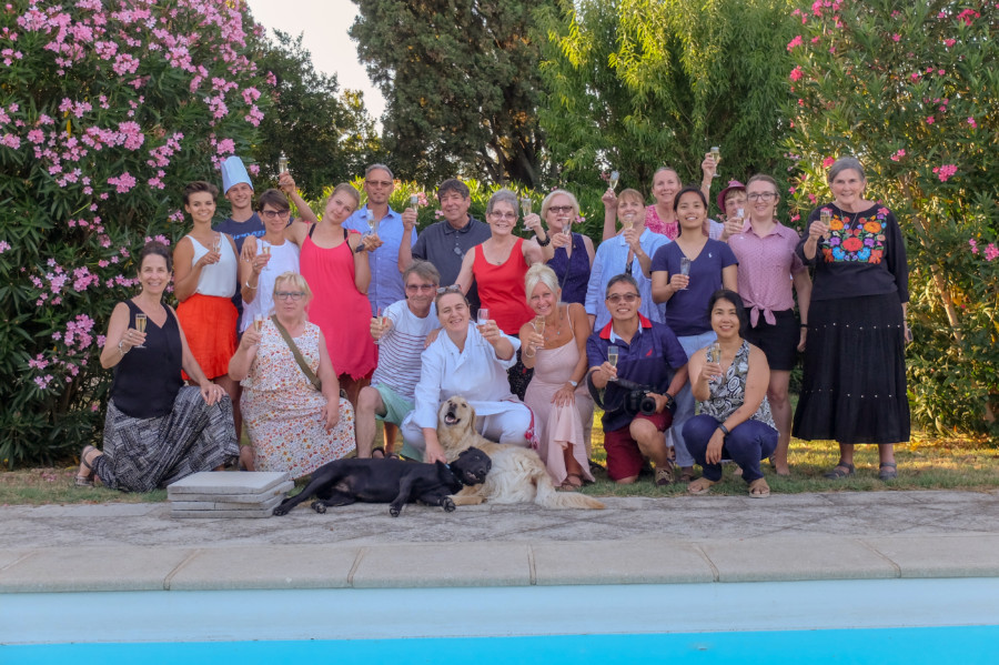 Group of Happy people on a Provence Walking tour holding wine glasses and posing 