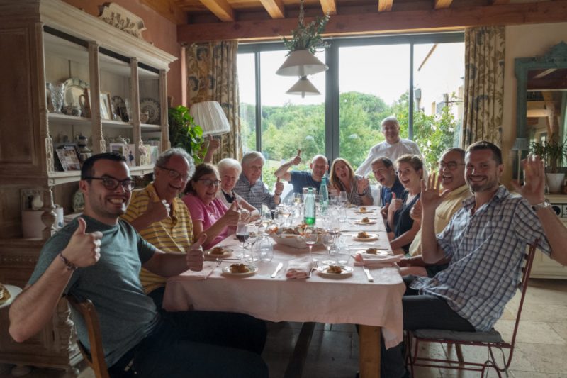 tour guests enjoying the fruits of their labors cooking at home with chef and friend Antoine