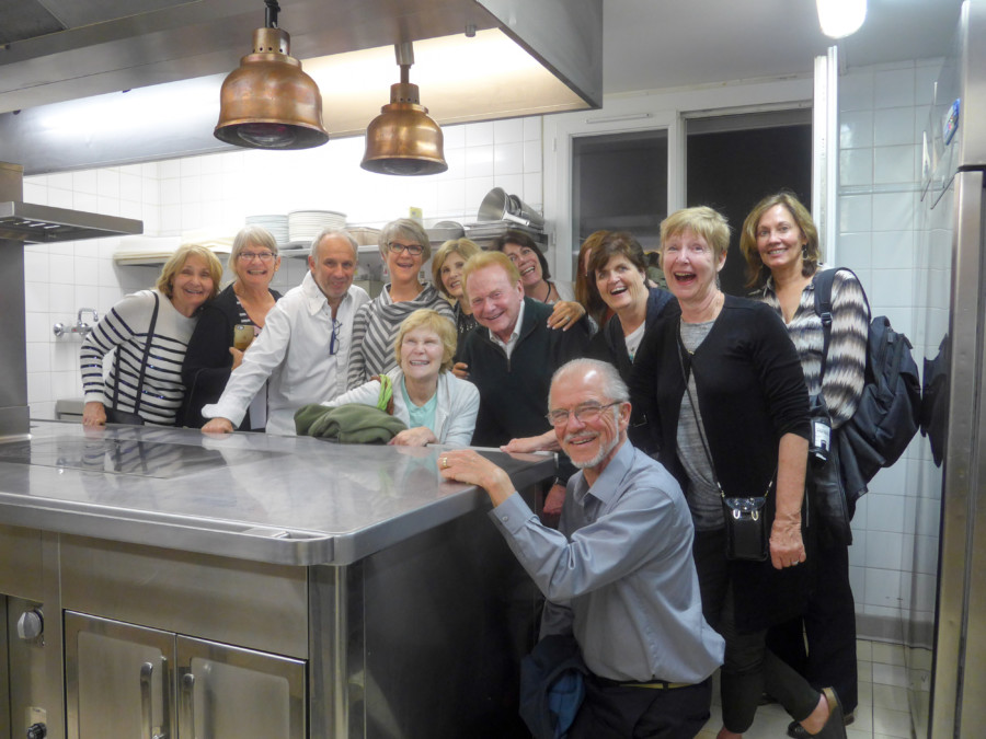 12 happy, smiling people in the kitchen - included in the 2016 Provence Tour
