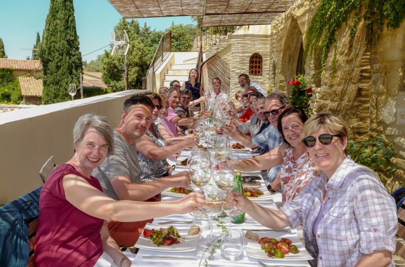 group of happy people having the best lunch on a rustic terrace, 2023 Provence tour dates