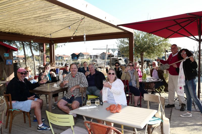 Happy people in a beach restourant, check our 2023 Bordeaux tour dates