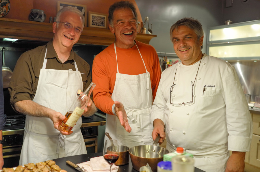 People in aprons on a cooking class, wine and food tasking. Page - Tour Prices & Inclusions