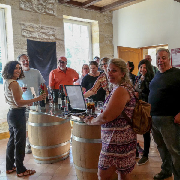 A Group of people is wine tasting withing the Bordeaux Tour Itinerary
