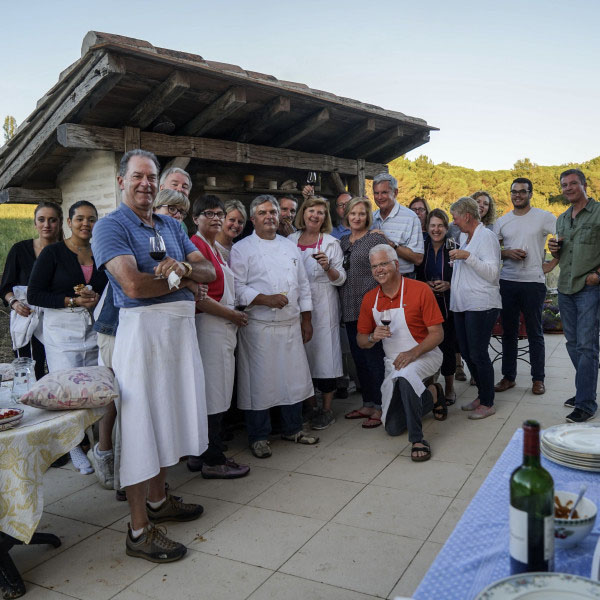 Group of people posing with raised glasses - Bordeaux Tour Itinerary