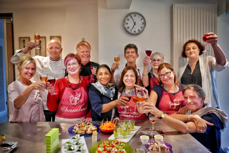 Group of happy people enjoying wine, in a beautiful garden. Page - 2023 Loire Valley Tour dates