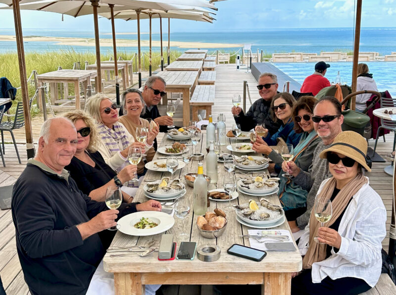 May 2023 tour guests enjoying lunch at the Pilat Dune overlooking the Arcachon Bay