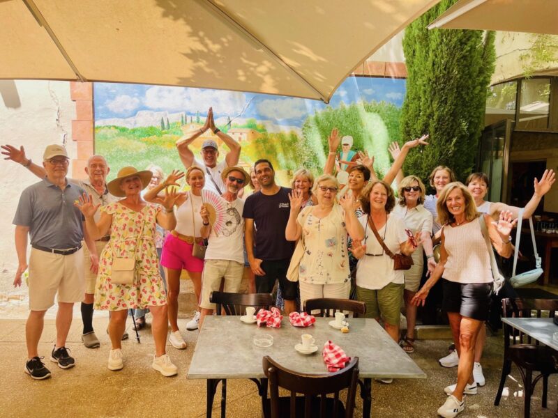 June 2025 tour guests at lunch in the countryside during France Off the Beaten Path Provence tour.