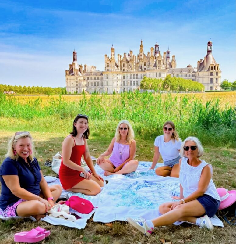 June Loire Valley tour guests enjoying relaxation time at Chambord castle during France Off the Beaten Path Loire Valley tour.