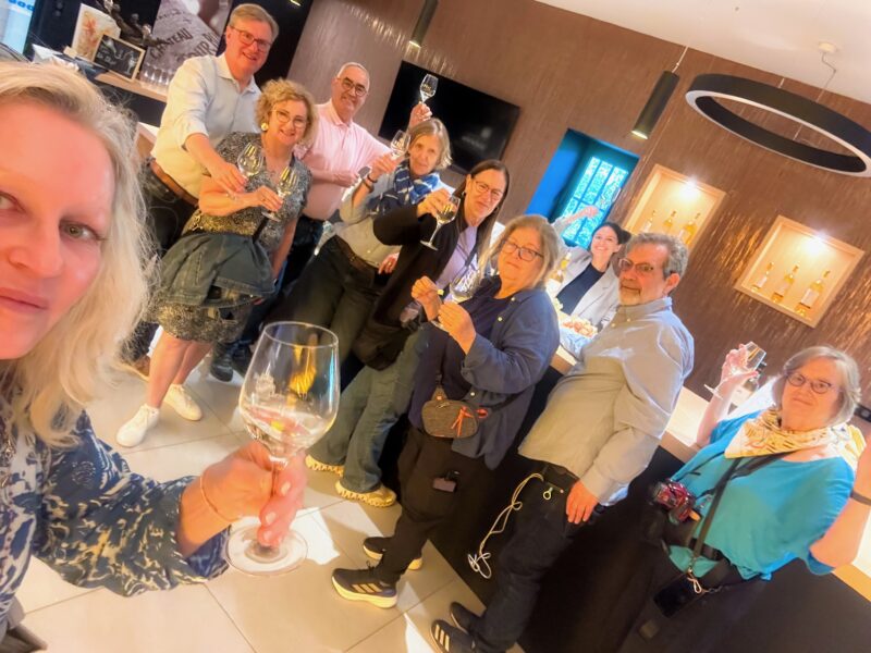 Bordeaux tour guests with raised glasses at our wine tasting in Sauternes - Bordeaux Tour Itinerary