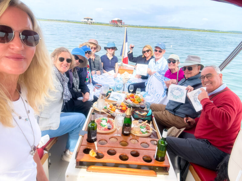 Tour guests with owner Christy Destremau and her team during Pinasse outing on Arcachon Bay, Bordeaux Tour.