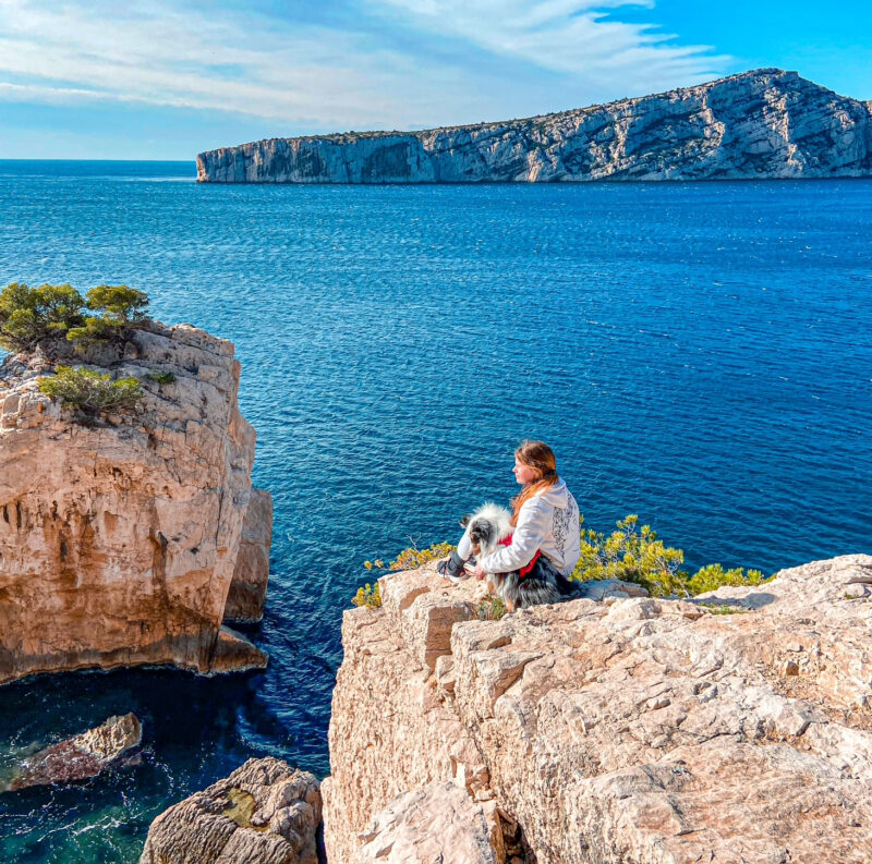 Chloé Destremau with her dog Nova at the Calanques of Sugiton.