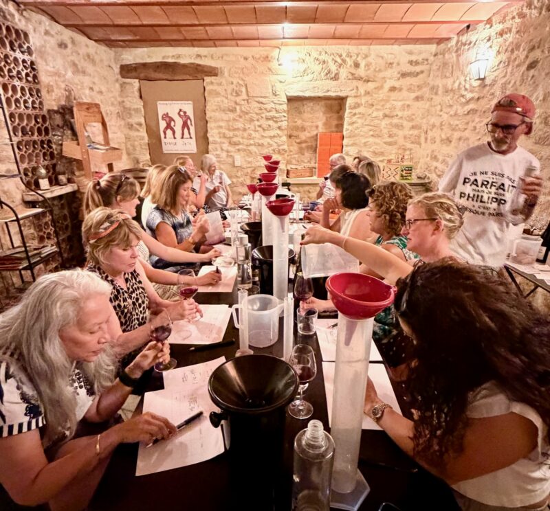 Tour guests participating in our hands-on wine blending workshop during France Off the Beaten Path Provence Tour.