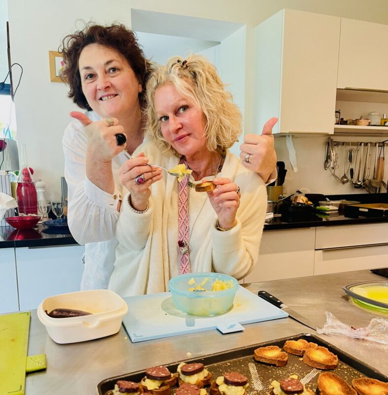 Angelique and Christy having fun in the kitchen at home cooking with France Off the Beaten Path Loire Valley tour guests.