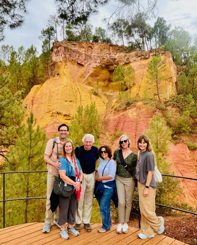 September Provence tour guests walking through thr ochre park of Roussillon. 